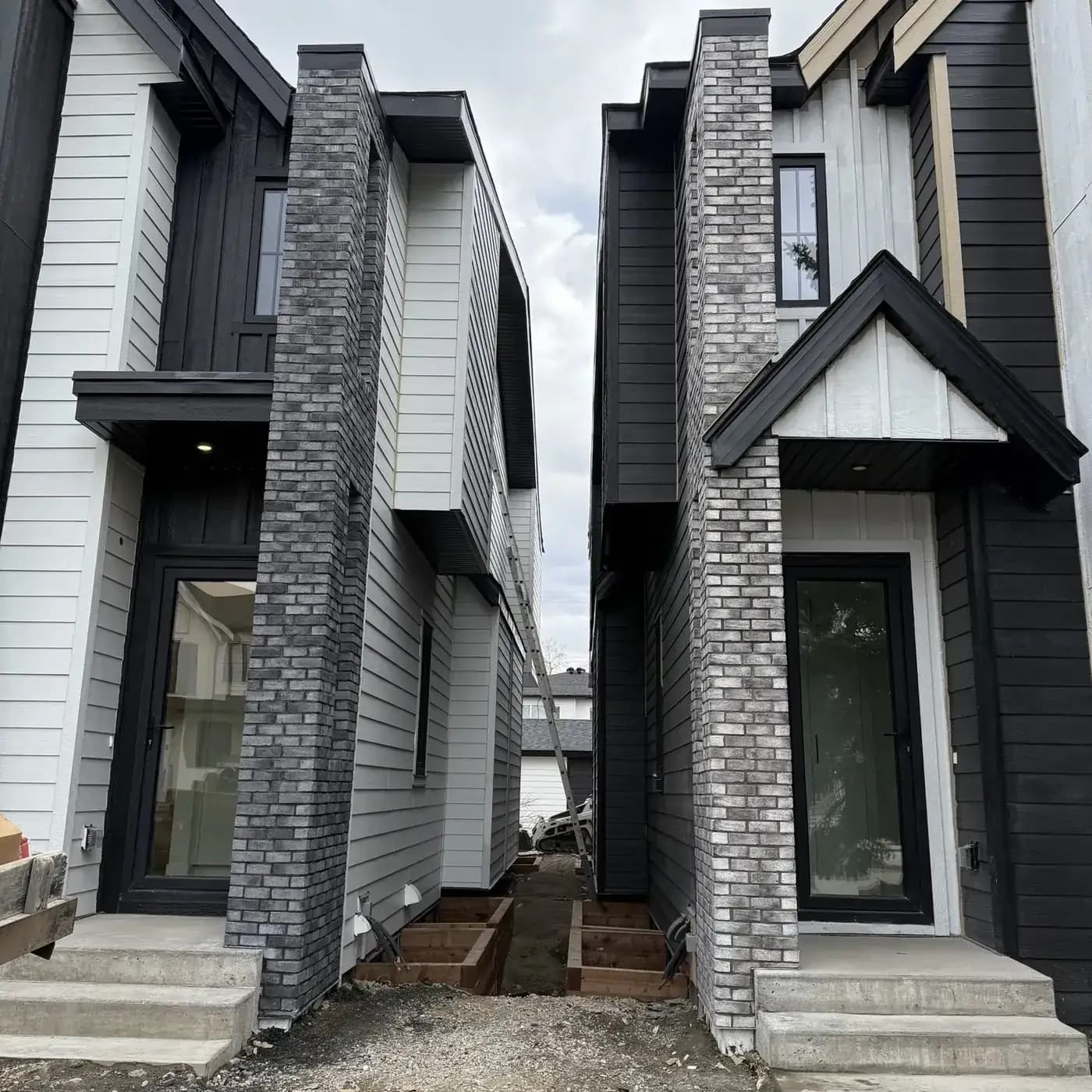 Premium residential exterior with stone entry columns and concrete walkway